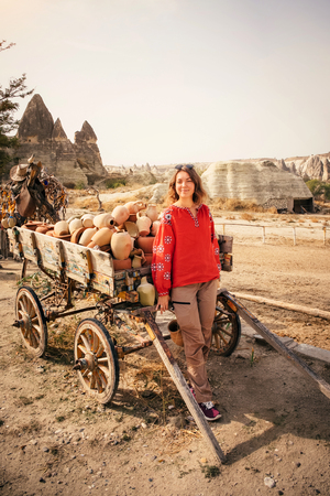 Young tourist woman hiking and explore Cappadocia culture in Goreme in mountain desert landscape while traveling in Cappadocia, turkeyの写真素材
