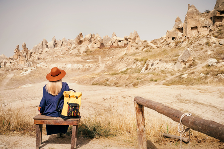 Young tourist woman hiking and enjoying mountain desert landscape while traveling in Cappadocia, turkeyの写真素材