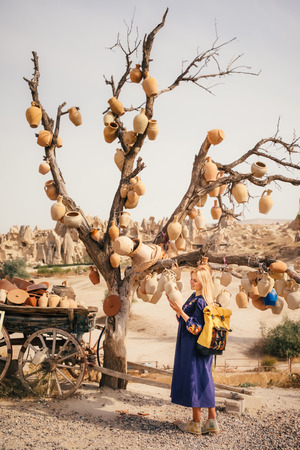 Young tourist woman hiking and explore Cappadocia culture in Goreme in mountain desert landscape while traveling in Cappadocia, turkeyの写真素材