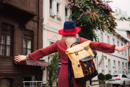 Happy beautiful tourist woman in hat and dress walking on Istanbul street and enjoy arabic city architecture, Turkeyの写真素材