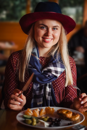 beautiful woman in hat and dress have taste breakfast food in turkish hostel while traveling to Istanbulの写真素材