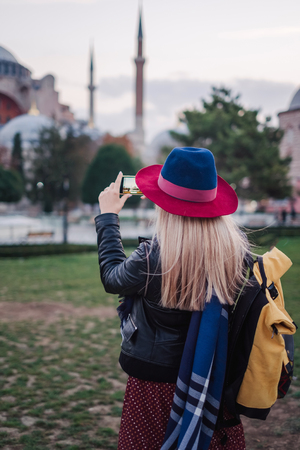 Woman enjoy beautiful view on Aya Sofia mosque ant take photo on mobile, Travel to Istanbul, Turkeyの写真素材