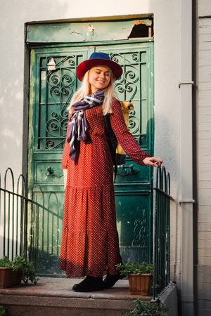 Happy beautiful tourist woman in hat and dress walking on Istanbul street and enjoy arabic city architecture, Turkeyの写真素材