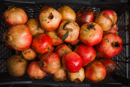 Big pile of ripe pomegranate on the marketの写真素材