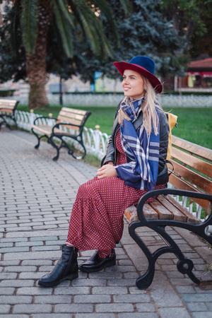 Happy beautiful tourist woman in hat and dress walking on Istanbul street and enjoy arabic city architecture, Turkeyの写真素材
