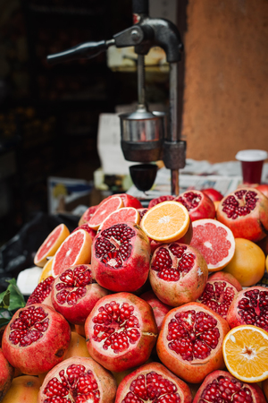 Heap of ripe citrus fruits and slice of them on the market for juiceの写真素材