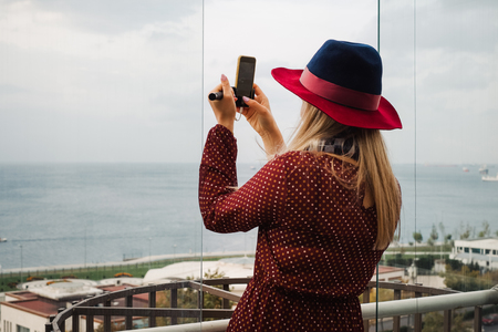 Tourist woman stay on the roof hotel with view on Bosporus strait in Istanbul and take photo, Travel to Turkeyの写真素材
