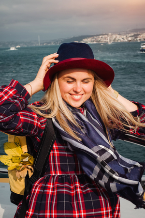 Turkey travel. Happy and positive beautiful woman on ferry at Istanbul through Bosporus straitの写真素材