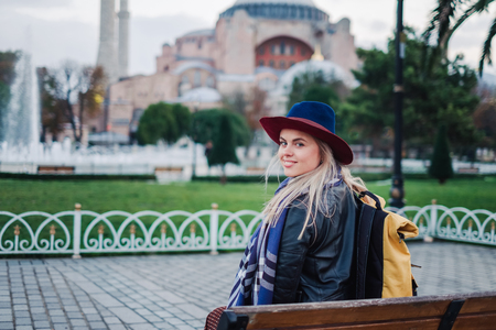 Woman sit on the bench and enjoy beautiful view on Aya Sofia mosque, Travel to Istanbul, Turkeyの写真素材