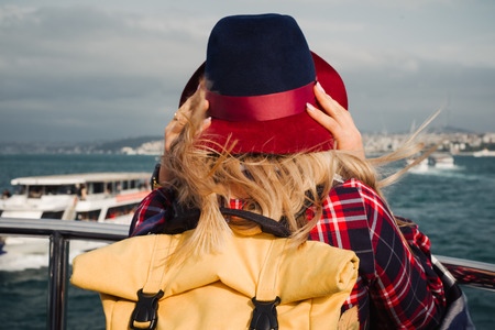 Turkey travel. Happy and positive beautiful woman on ferry at Istanbul through Bosporus straitの写真素材
