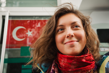 Beautiful woman portrait on turkish national flag background, Travel to Turkeyの写真素材