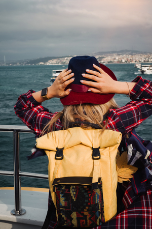 Turkey travel. Happy and positive beautiful woman on ferry at Istanbul through Bosporus straitの写真素材