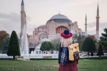 Woman enjoy beautiful view on Hagia Sophia Cathedral, famous islamic Landmark mosque, Travel to Istanbul, Turkeyの写真素材
