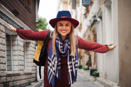 Happy beautiful tourist woman in hat and dress walking on Istanbul street and enjoy arabic city architecture, Turkeyの写真素材