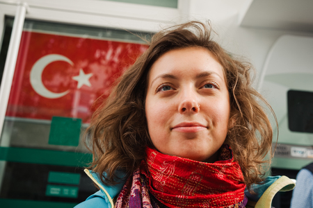 Beautiful woman portrait on turkish national flag background, Travel to Turkeyの写真素材
