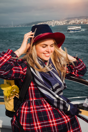 Turkey travel. Happy and positive beautiful woman on ferry at Istanbul through Bosporus straitの写真素材