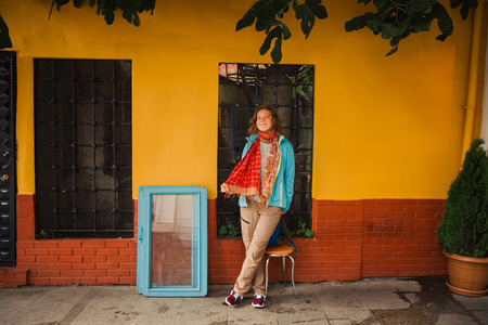 Traveler woman stay near yellow wall background while walking on Istanbul street. Travel to Turkeyの写真素材