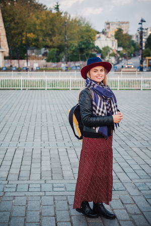 Happy beautiful tourist woman in hat and dress walking on Istanbul street and enjoy arabic city architecture, Turkeyの写真素材