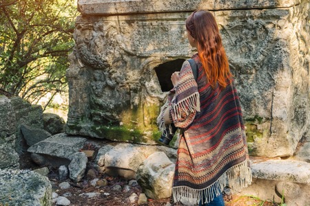 Tourist photographer woman explore ancient Lycia and ruins of Olympos city near Cirali beach while travel in Turkeyの写真素材