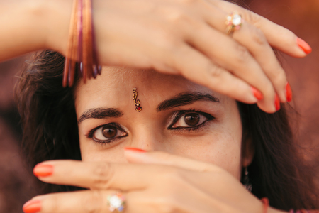 Portrait of beautiful indian woman in red saree dancing traditional Bharatanatyam danceの写真素材