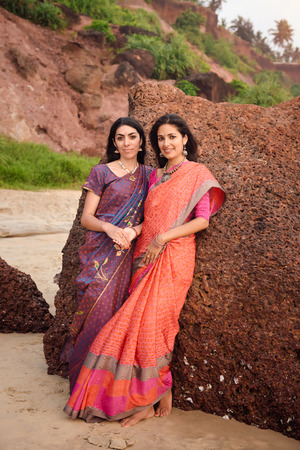 Fashion shoot of indian woman in traditional clothes. Friends girl in beautiful saree standing on...