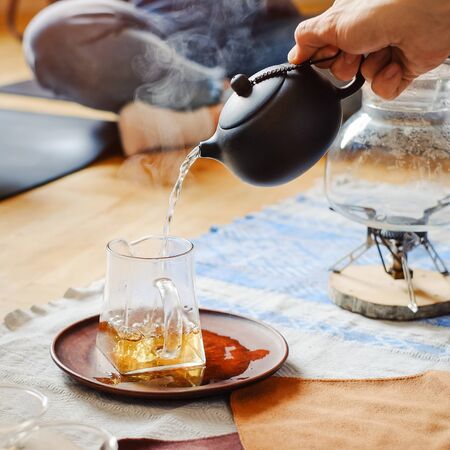 Master making chinese tea in traditional ceremony and pouring tea from teapotの写真素材