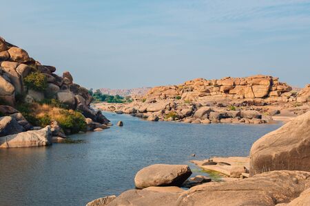 Architecture of ancient ruins of temple near river in Hampi, Karnataka, Indiaの写真素材