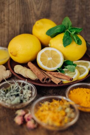 Lemon and healthy tea with turmeric and honey for better immunity system. Natural products on wooden backgroundの写真素材