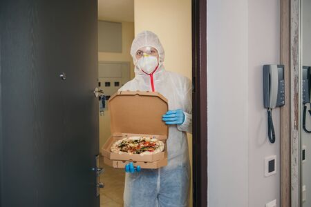 Safe pizza home delivery during virus outbreak and quarantine.の写真素材
