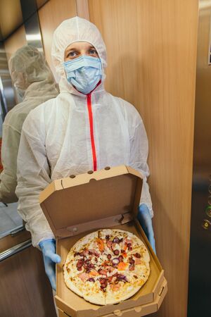 Safe pizza home delivery during virus outbreak and quarantine.の写真素材