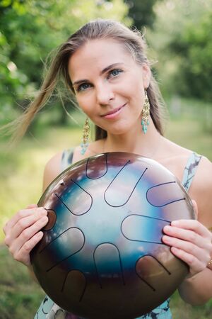 Woman with authentic drum musical instrumentの写真素材