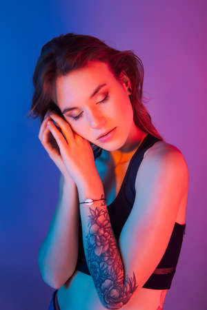 Beautiful woman portrait in retro style on the neon lightの写真素材