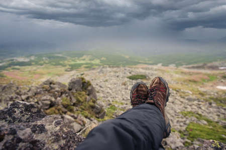 Tourist on the mountains top before rain and stormの写真素材