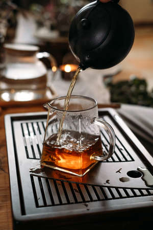 Traditional tea ceremony - pouring chinese oolong in glass cupの写真素材