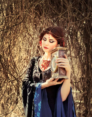 Portrait of beautiful medieval woman in fairy forestの写真素材
