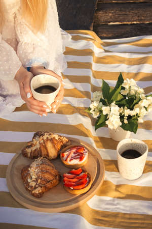 Woman enjoy tasty coffee on picnic outdoorsの写真素材