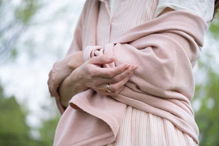 Confident business woman outdoors with cross hands togetherの写真素材