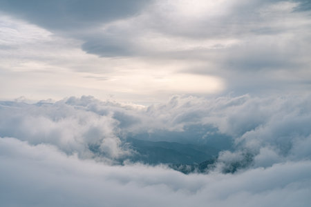 Flowing clouds in winter mountain at sunsetの写真素材