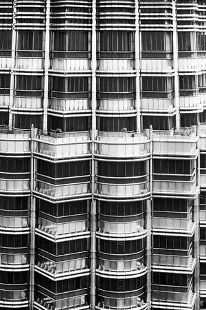 ten floors of an office round skyscraper, repeating patterns of the balconies, windows and metal structure of the building, Petronas tower, Kuala lumpur, windows, black and white photographのeditorial素材