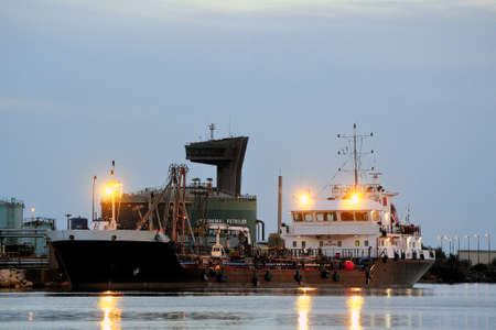 oil terminal of Fos on sea beside Marseille, a cargo liner moored with the quay the night のeditorial素材