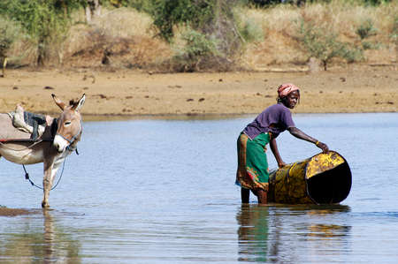 filling and transportation of water bottles at lake is for women to irrigate cropsのeditorial素材