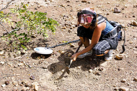 a French gold prospector at work with his metal detector in the African savannah of Burkina Fasoのeditorial素材