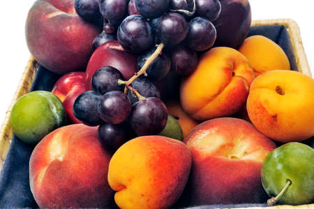 Basket of fruit isolated on white background in studioの写真素材