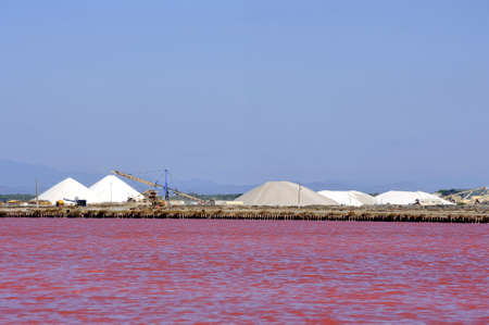 Site operating sea salt saline Aigues-Mortes in the season when a pink algae grow in the water,...