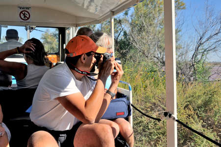 tourists in the tourist train to visit the salt business of Aigues-Mortes and to tour the mine salt site.のeditorial素材