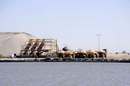 Site operating sea salt saline Aigues-Mortes with big machines and trucks working for the salt...