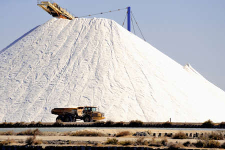 Site operating sea salt saline Aigues-Mortes with big machines and trucks working for the salt storageの写真素材