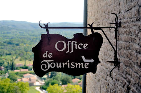 Sign indicating indication the entrance to the tourist office in the old town of Vezenobres in the French department of Gardのeditorial素材