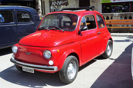 Fiat 500 red photographed in vintage car rally Town Hall Square in the town of Ales, in the Gard...
