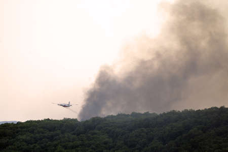 Tracker water bomber in the sky of southern France from extinguishing a forest fire.